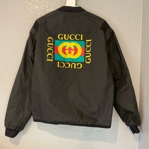 A black Gucci bomber jacket